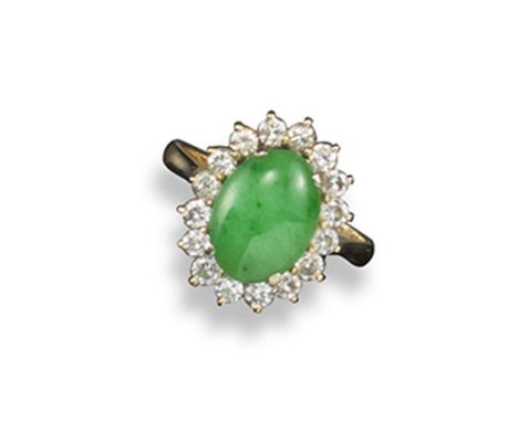 A jade and diamond cluster ring, the oval-shaped jade cabochon is set within a surround of round brilliant-cut diamonds in pl