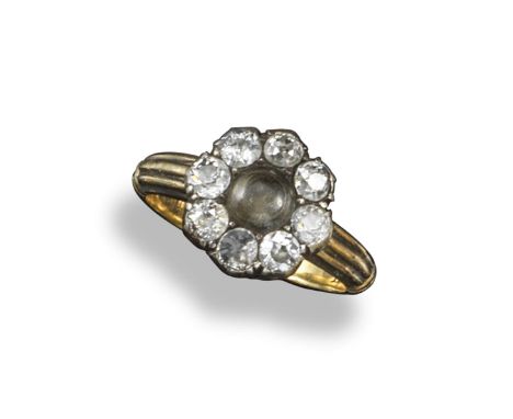 A late Victorian diamond cluster locket ring, centred with a small circular locket containing hair and covered with a crystal