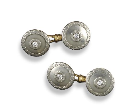 A pair of diamond-set cufflinks, the circular links are centred with old circular-cut diamonds within two concentric carved l