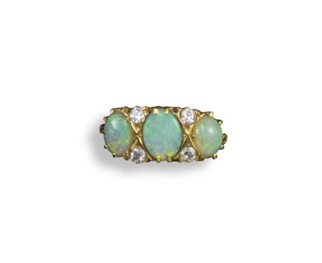 An opal and diamond seven stone ring, the three graduated oval-shaped opal cabochons are each spaced with two old circular-cu