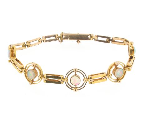 An early 20th century gold opal mounted bracelet, the circular opal cabochons are set within gold concentric circles on fancy
