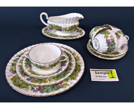 A collection of Worcester Vine Harvest pattern table ware including dinner plates, side plates, soup bowls, cups, saucers, et