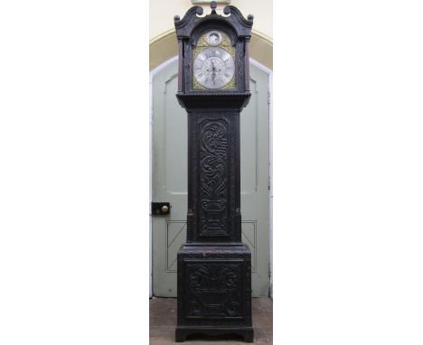 An early 19th century oak longcase clock, the casework with later geometric carved detail, enclosing a brass and silvered bro