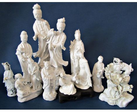 Twelve Chinese blanc de chine porcelain figures including Guanyin, mythical beast standing on a boulder and others, tallest: 