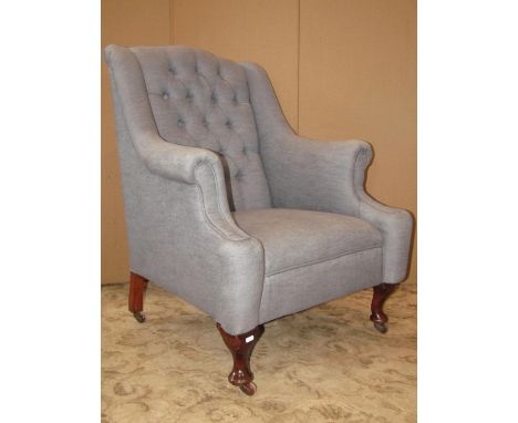 An Edwardian drawing room chair, with shaped outline, swept and rolled arms, pale blue upholstered with deep button back on s