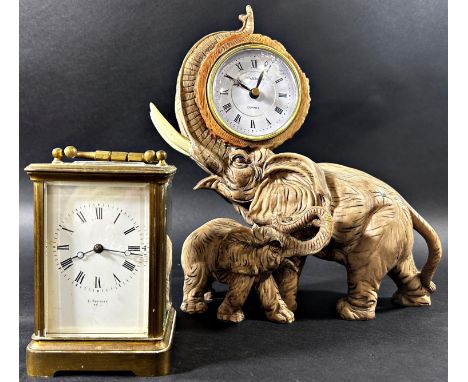 A brass carriage clock with eight day striking movement together with a further mantle clock in the form of an elephant and i