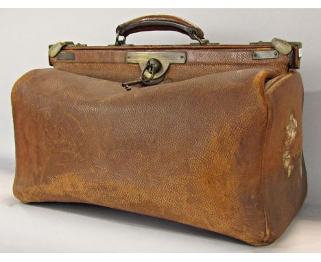 A vintage leather Gladstone bag with decent stitching and a large vintage Pukka suitcase. 