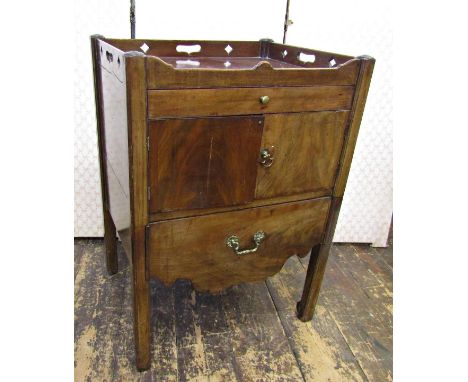 A Georgian mahogany tray top commode, the front elevation enclosed by a very shallow drawer, set within a shaped outline 