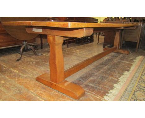 An oak refectory table, the heavy plank top raised on a simple stretcher base united by a central rail, (with receipt for pur