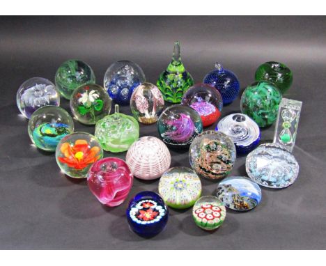 Twenty three various glass paperweights with Caithness, Whitefriars, examples with millefiori and floral designs and a glass 