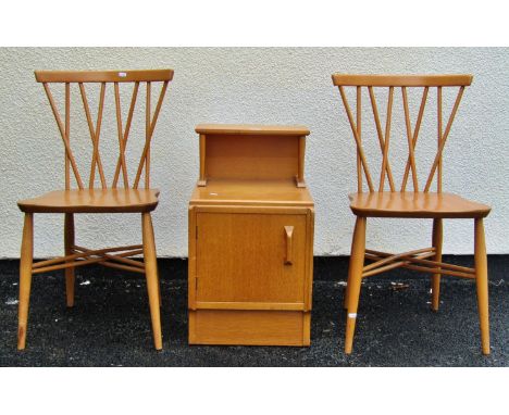 A pair of Ercol dining chairs with shaped elm seats and stick backs together with a further side cupboard with raised back 
