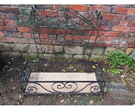 A free standing steel planter with open scrollwork detail, 66cm wide x 22cm deep x 73cm high, together with one other (2) 