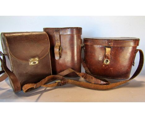 Three pairs of vintage binoculars in their original leather cases. 