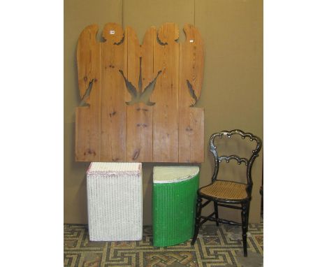 A vintage stripped pine fretwork wall plaque in the form of two stylised angels, 98cm wide x 107cm high together with a Victo