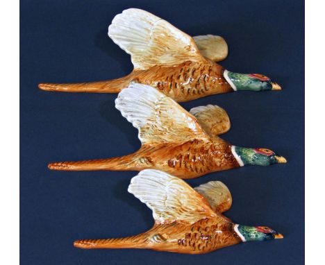 A trio of three graduated Beswick flying pheasant wall plaques, cranberry ware sugar basin, a Japanese style oviform vase, et