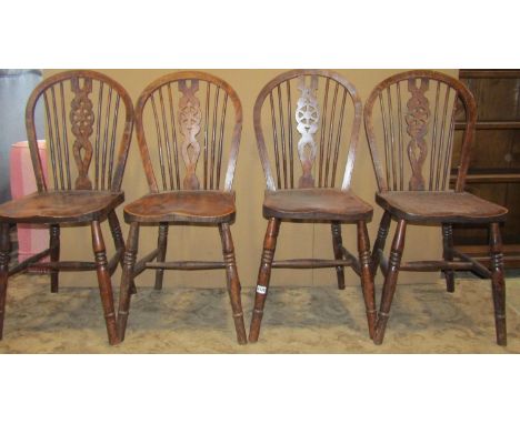 Set of four stained elm beechwood Windsor hoop and stick back dining chairs, with pierced wheel splats 