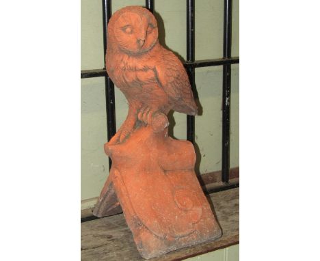 A simulated terracotta ridge tile with owl surmount, 43cm high 