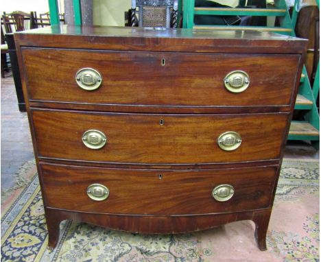A Regency mahogany bowfronted chest of three long drawers with caddy top, raised on swept supports with embossed brass plate 