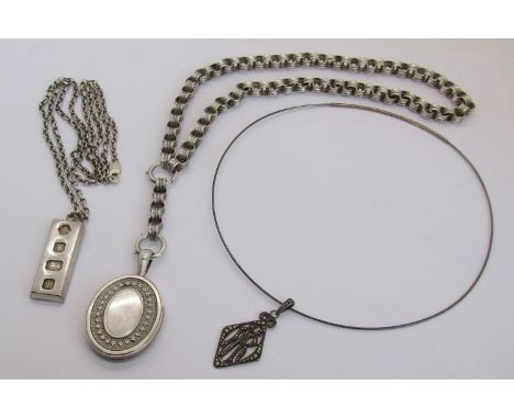 Three silver pendant necklaces; a Victorian style embossed locket hung from belcher chain, a 1970s ingot pendant necklace and