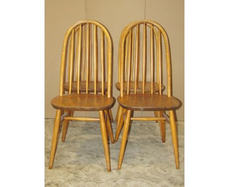 Set of four vintage stained elm and beechwood high hoop and stick back dining chairs with solid seats, raised on simple turne