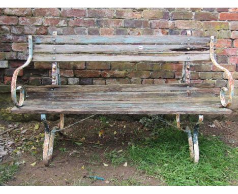 A vintage painted and weathered sprung steel garden bench with wooden lathes, (af) 150cm wide 