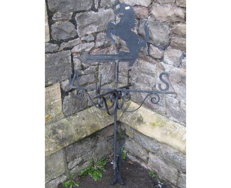 An iron weather vane with simple open scrollwork detail beneath a rearing horse final/pointer, 115cm high 