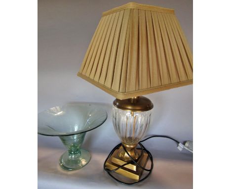 A cut glass vase shaped table lamp with a brass finish, and a cloudy blue glass fruit bowl. 