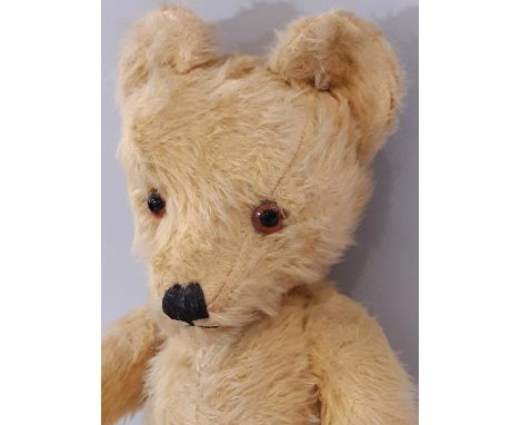 Vintage teddy bear, mid 20th century, with long golden plush, large ears, pronounced muzzle, glass eyes, stitched nose and mo