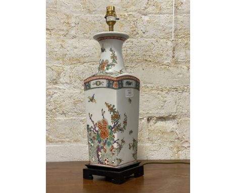 A polychrome enamelled Kangxi style squared lamp base, depicting flowers and butterflies, together with a shade. H70cm.&nbsp;