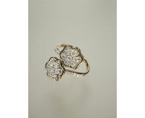 A 9ct fold cluster toi et moi style ring set seven round cut diamonds within a baguette set border and five diamonds to each 