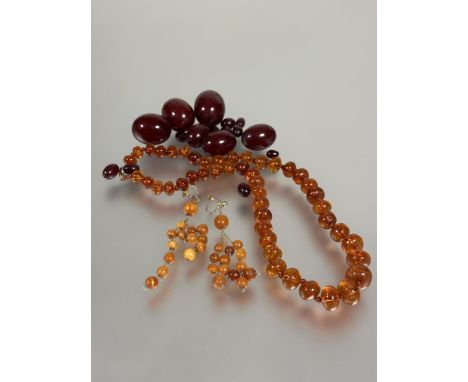 A collection of amber beads and mounted jewellery to include a strand of graduated mid coloured amber beads with craquelure s