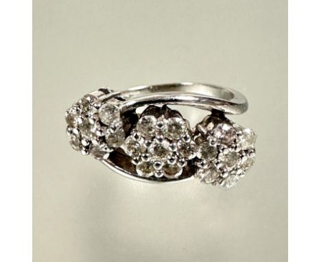 A Iliana 18ct white gold triple floral diamond cluster ring each diamond approximately 0.05ct within a scrolling shank total 