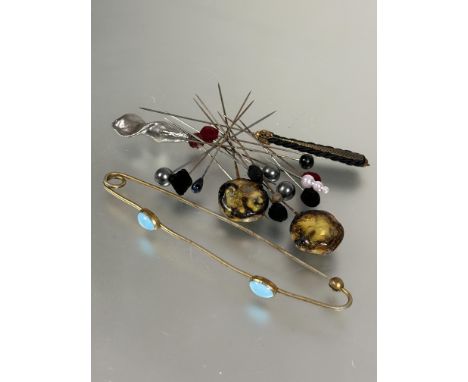 A collection of thirteen various vintage hat pins and large oval brass set twin turquoise ceramic oval beads L x 16cm (14)