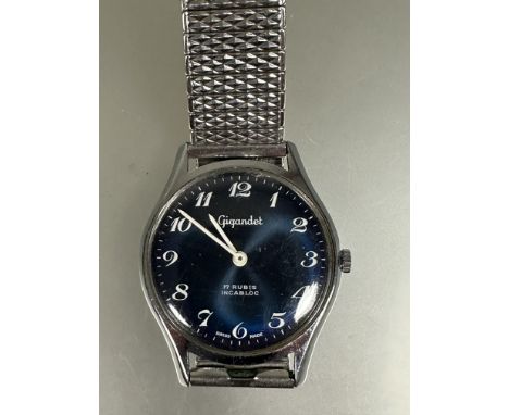 A vintage Gents Swiss Gigandet manual wind stainless steel wrist watch with blue dial and luminous hands and arabic numerals 