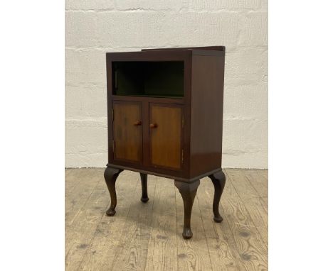 A Vintage mahogany and oak side cabinet, with an open shelf above two cupboard doors, raised on cabriole supports. H77cm, W47