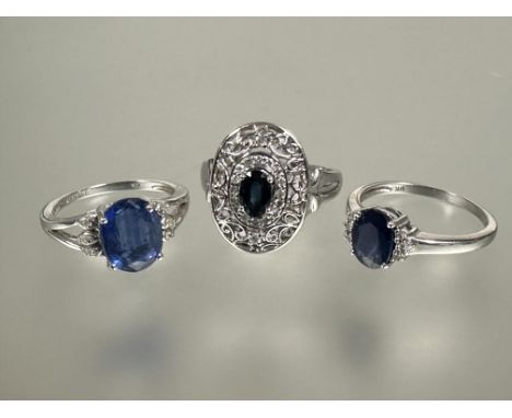 A group of three 9ct white gold gem set rings to include an oval cut blue stone ring with surround of miligrain set daimonds 