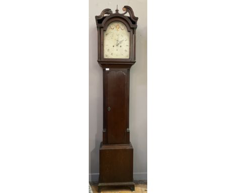 An early 19th century oak longcase clock, the hood with swan neck pediment above fluted pilasters and a full length trunk doo