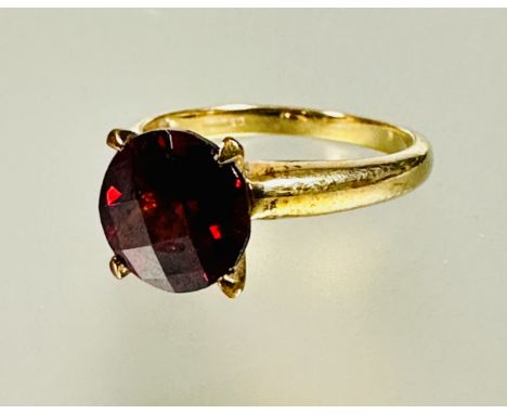 A 9ct gold red stone solitaire ring set in four claw setting approximately 2ct N 2.98g