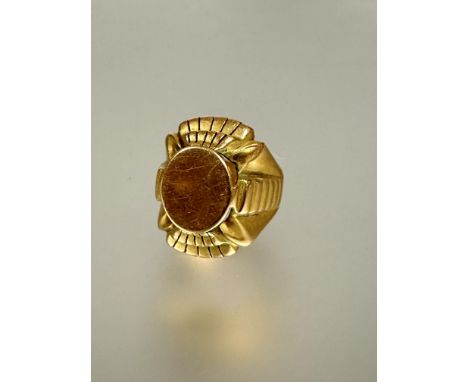 A 1920s Egyptian revival heavy yellow metal signet style cast ring L x 2.5cm W 2cm R 21.94g&nbsp;