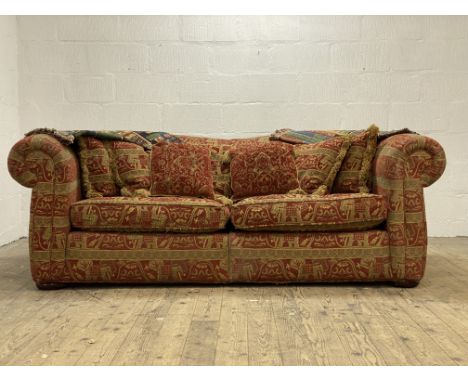 A Duresta two seat Chesterfield sofa, complete with squab and scatter cushions, raised on compressed bun supports (upholstery