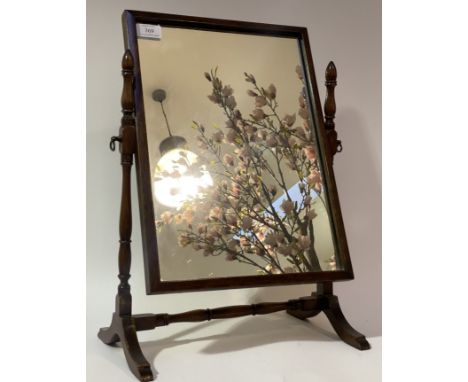 An early 20th century vanity mirror, the rectangular plate swivelling between ring turned uprights. H51cm.&nbsp;