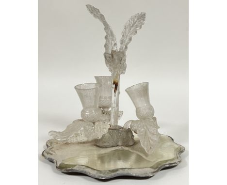 An art glass table centrepiece/epergne in the form of thistles, raised on a mirror base (a/f) (h- 30cm, w- 28cm)