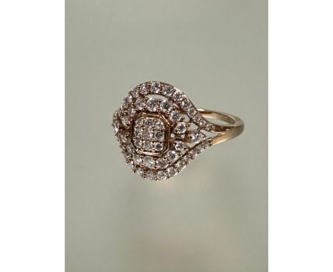 A 9ct rose gold ring, the center with nine claw set diamonds within two radiating rows of diamond points O 2.08g&nbsp;