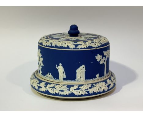 A Jasperware dark blue cheese dome decorated with classical figures. (marked K) (h-20cm w-26cm)