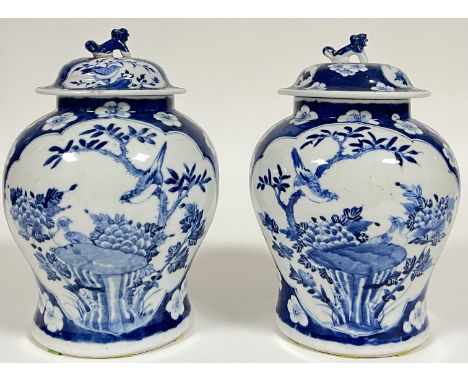 A pair of Chinese blue and white porcelain Kangxi-revival covered vases of baluster form, with panel decoration of birds and 