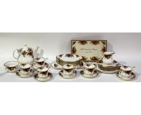 A Royal Albert country rose pattern tea service comprising, a teapot (h-20cm), six tea cups, six saucers, a sugar bowl, a mil