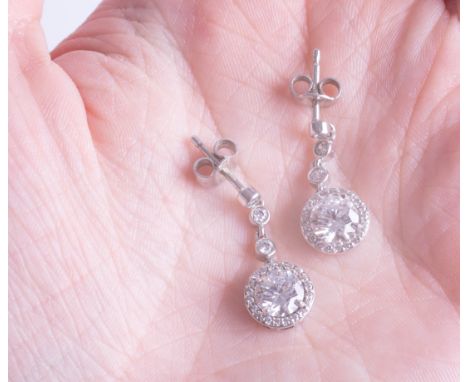 A pair of silver dress earrings with paste diamonds.