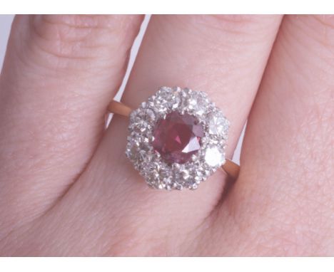 An 18ct ruby and diamond cluster ring, size M.
