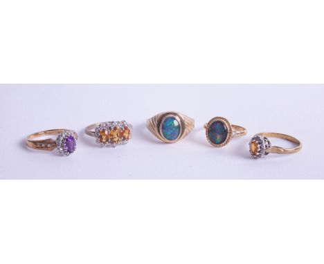 Four 9ct gold dress rings, approx 12.50g, together with a unmarked yellow metal and opal set dress ring (5.40g).