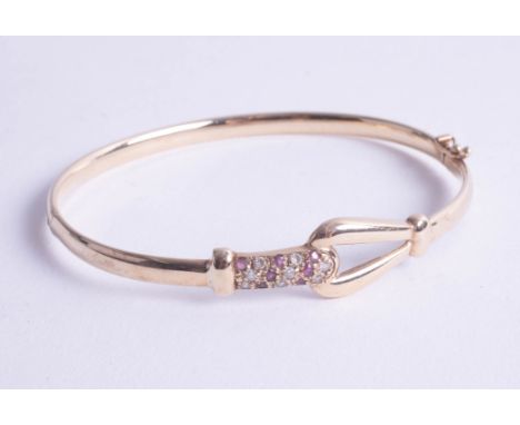 A 9ct diamond and ruby set bangle.